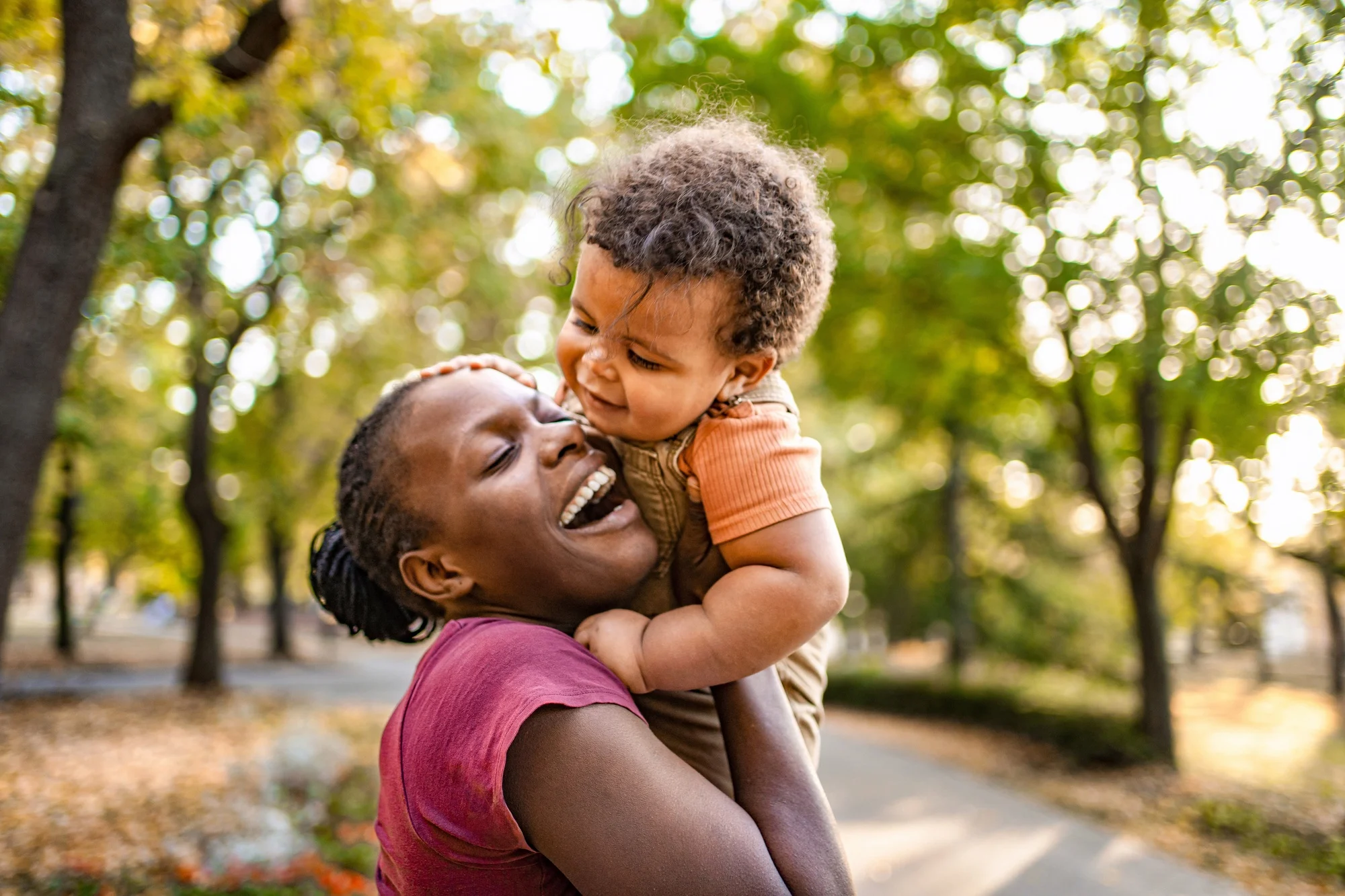 Joyful moments shared between mother and child in a sunlit park
